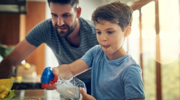 boy doing chores with his dad