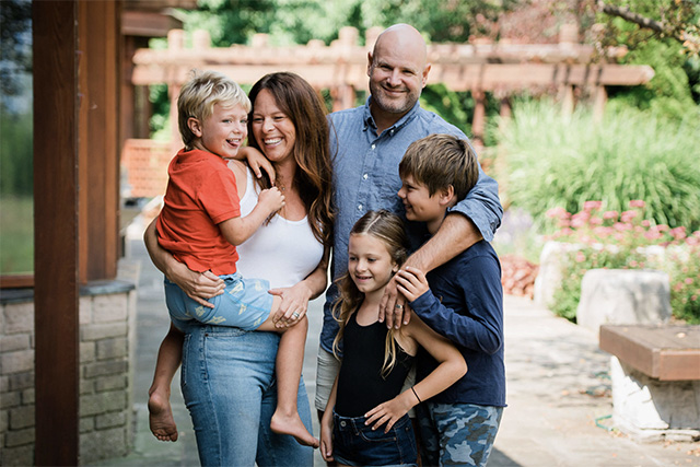 a professional photo of a family dressed in blues and white with a pop of orange, one of the best family photo outfit ideas