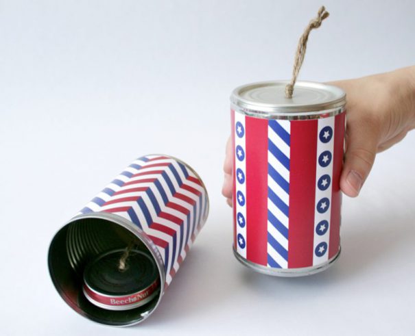 Metal cans decorated red, white and blue to look like firecrackers for a 4th of July craft