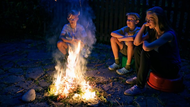 sitting around a campfire telling ghost stories for kids
