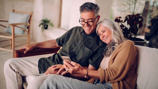 grandparents looking at Tinybeans app on the phone