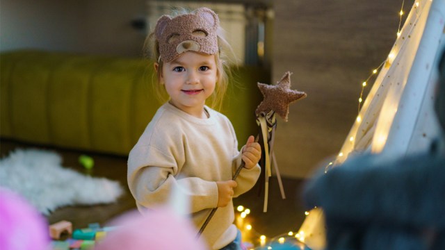 A toddler dressed in a bear costume for a story on how to compliment a girl
