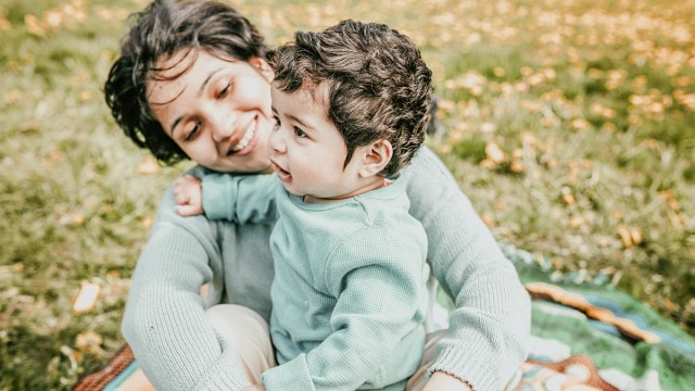 a mother looking at her toddler instead of the camera, which is one of the best family photo ideas with toddlers