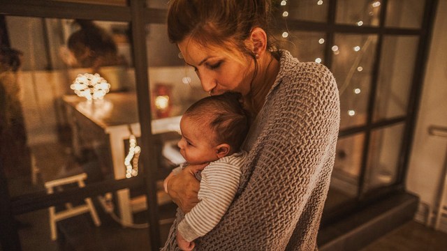mom holding baby at night