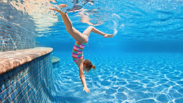 little girl playing swimming pool games