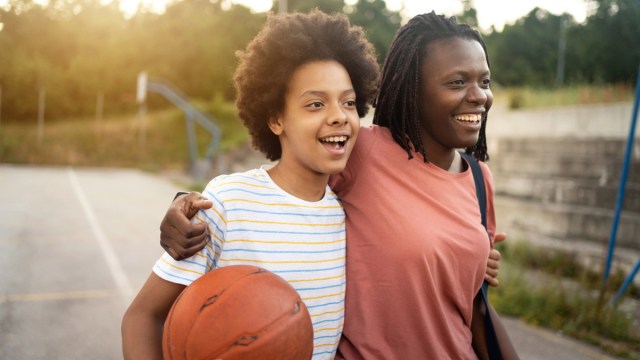 A mom and son smiling after playing basketball for a story on sun signs and your big kid's personality