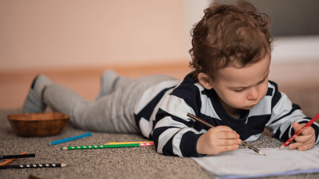 little boy enjoying coloring pages for toddlers